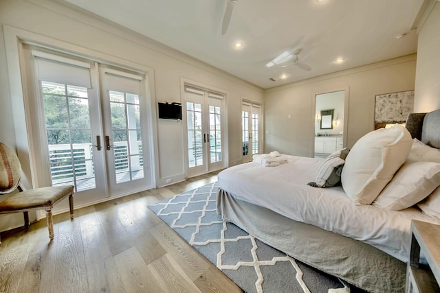 bedroom featuring access to outside, french doors, multiple windows, and wood finished floors