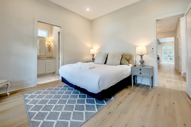 bedroom featuring connected bathroom, light wood-style flooring, recessed lighting, baseboards, and crown molding