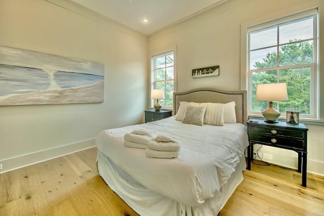 bedroom with recessed lighting, baseboards, crown molding, and hardwood / wood-style floors