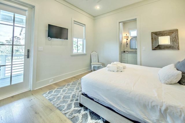 bedroom with access to outside, recessed lighting, ensuite bathroom, light wood-type flooring, and baseboards