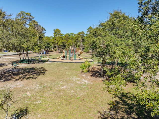 exterior space featuring playground community and a yard