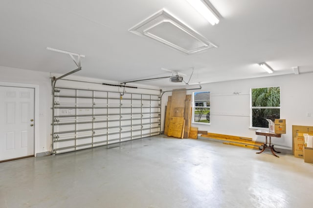 garage with a garage door opener and baseboards