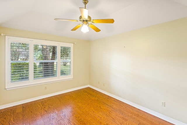 unfurnished room with a ceiling fan, wood finished floors, and baseboards