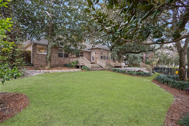 view of yard featuring a wooden deck and fence