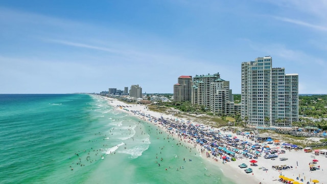 drone / aerial view featuring a view of city, a beach view, and a water view