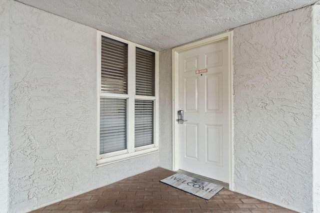 property entrance with stucco siding