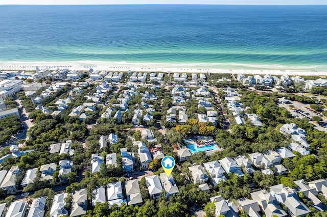 birds eye view of property featuring a water view, a residential view, and a view of the beach