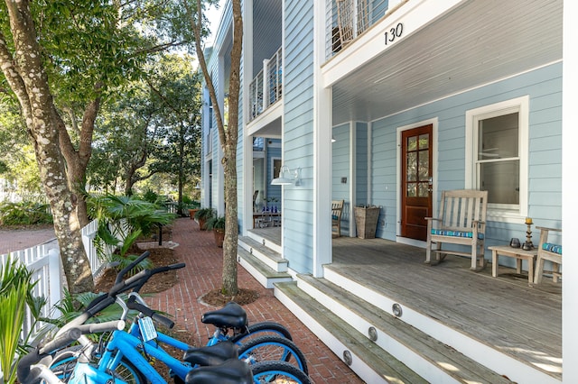 view of patio / terrace with fence and a porch