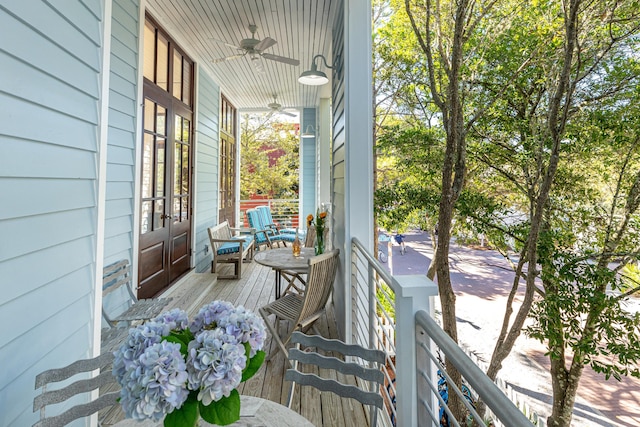 wooden terrace with covered porch and ceiling fan