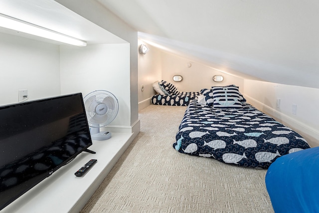 bedroom with vaulted ceiling, carpet, and baseboards