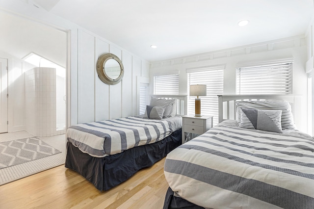 bedroom with wood finished floors and recessed lighting