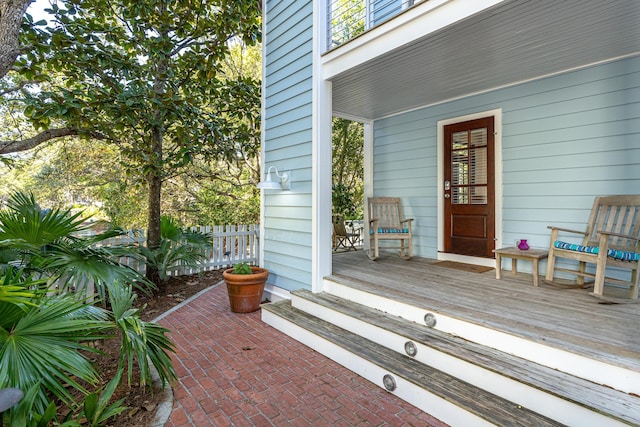 exterior space with a porch and fence