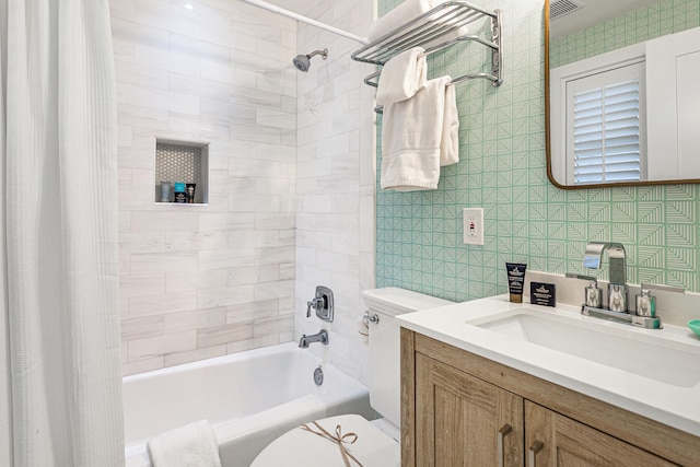 full bath with shower / bath combo, visible vents, vanity, and toilet