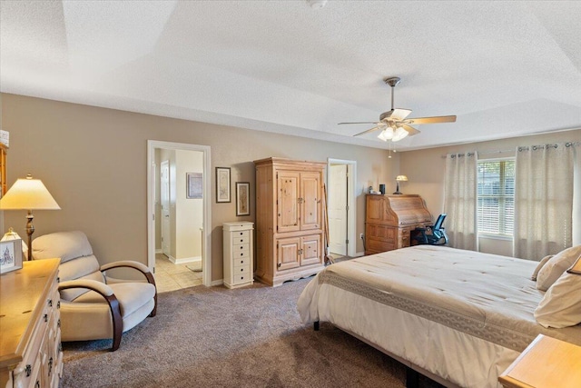 bedroom with carpet floors, ceiling fan, a textured ceiling, ensuite bath, and baseboards