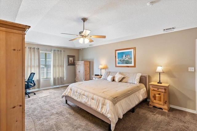 bedroom featuring carpet, visible vents, a textured ceiling, and baseboards