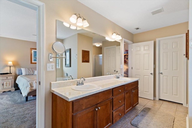 full bath with ensuite bath, a sink, visible vents, and a stall shower