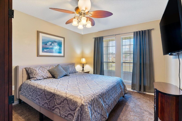 bedroom with a textured ceiling, carpet floors, a ceiling fan, and baseboards