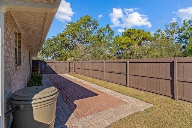 view of patio with a fenced backyard and a gate