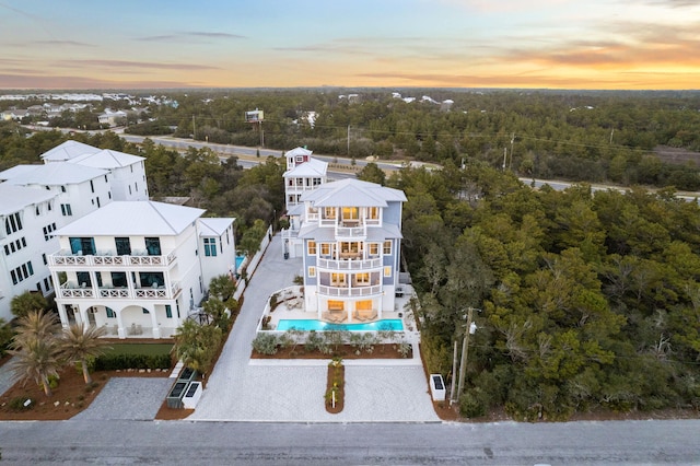 drone / aerial view featuring a wooded view