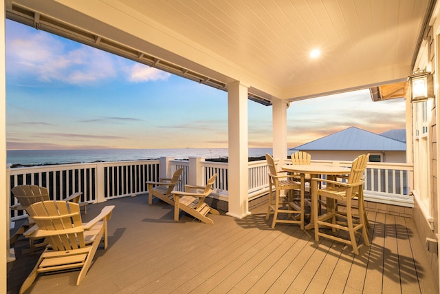 deck with a water view and a beach view