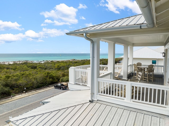 deck with a water view and a view of the beach