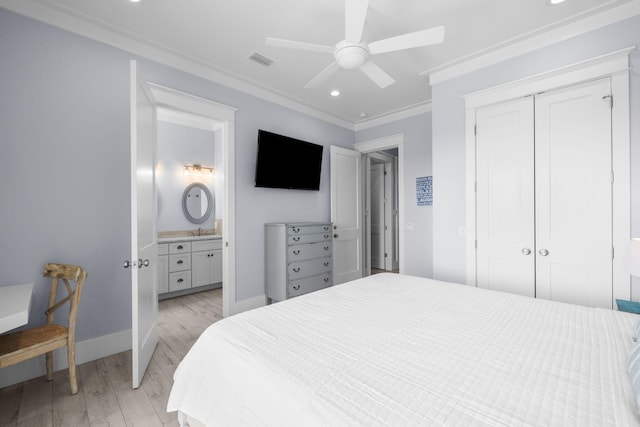 bedroom with visible vents, baseboards, a closet, light wood-type flooring, and crown molding