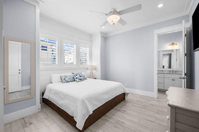 bedroom featuring light wood-style floors, baseboards, ornamental molding, and a sink