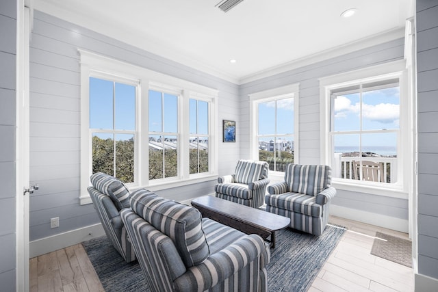 interior space with visible vents, baseboards, a wealth of natural light, and wood finished floors