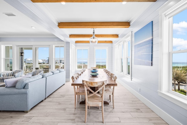 interior space featuring visible vents, beam ceiling, and a wealth of natural light