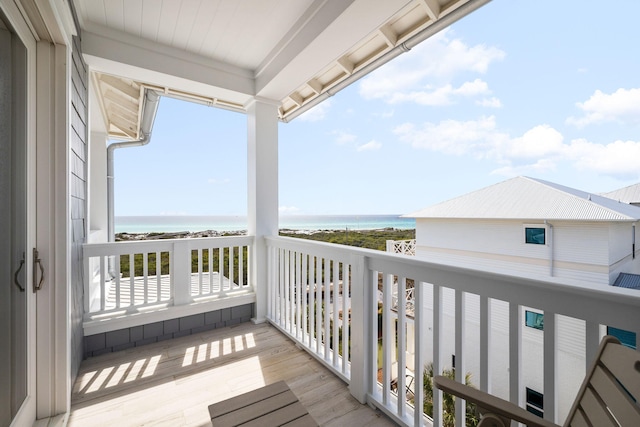 balcony featuring a water view and a view of the beach