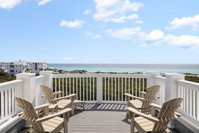 deck with a water view and a beach view