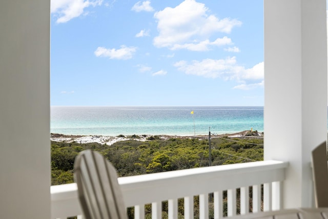 balcony with a water view and a beach view