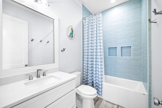 bathroom with wood finished floors, vanity, toilet, and shower / bath combo with shower curtain