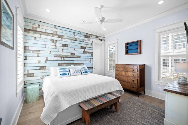 bedroom with baseboards, a ceiling fan, ornamental molding, wood finished floors, and recessed lighting