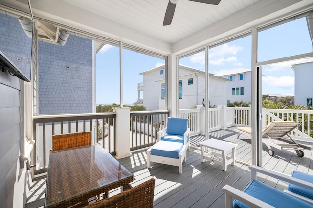 sunroom / solarium featuring ceiling fan