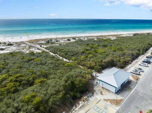 aerial view with a water view and a beach view