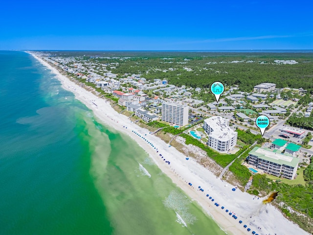 birds eye view of property featuring a beach view and a water view