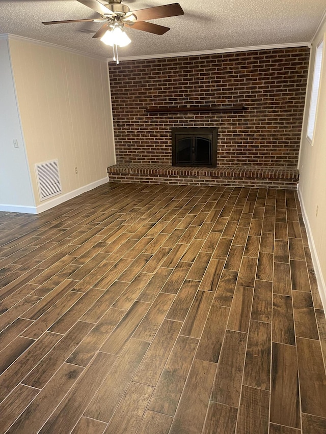 unfurnished living room with crown molding, a fireplace, visible vents, and wood tiled floor