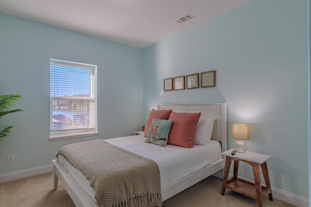 bedroom featuring baseboards, visible vents, and carpet flooring