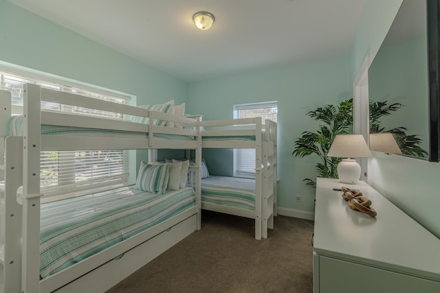 bedroom featuring carpet floors and baseboards