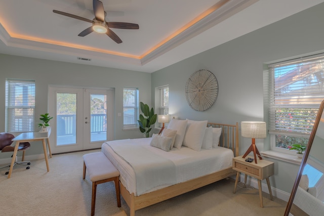 carpeted bedroom with access to exterior, french doors, a raised ceiling, visible vents, and baseboards