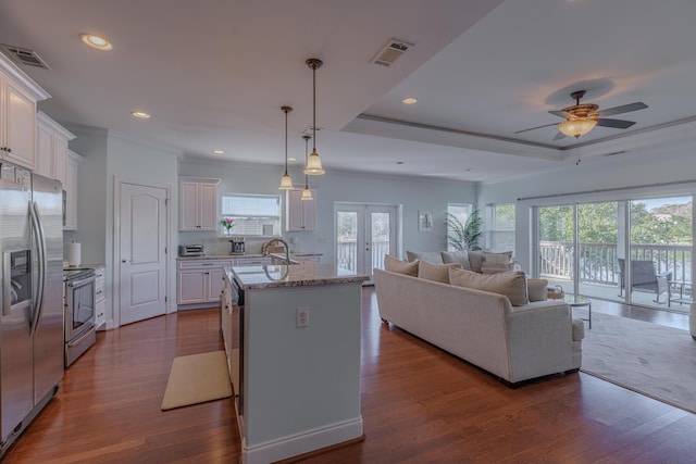 kitchen with visible vents, stainless steel appliances, dark wood-style flooring, and open floor plan