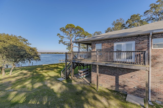 exterior space featuring stairway and a deck with water view