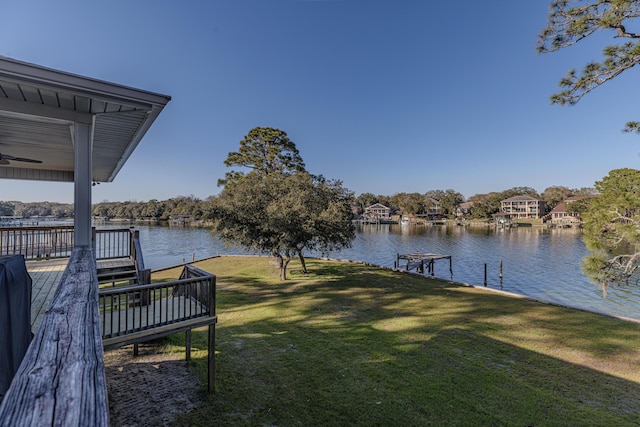 dock area featuring a water view and a lawn