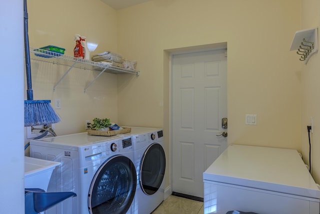 laundry room featuring washer and dryer, laundry area, and light tile patterned flooring