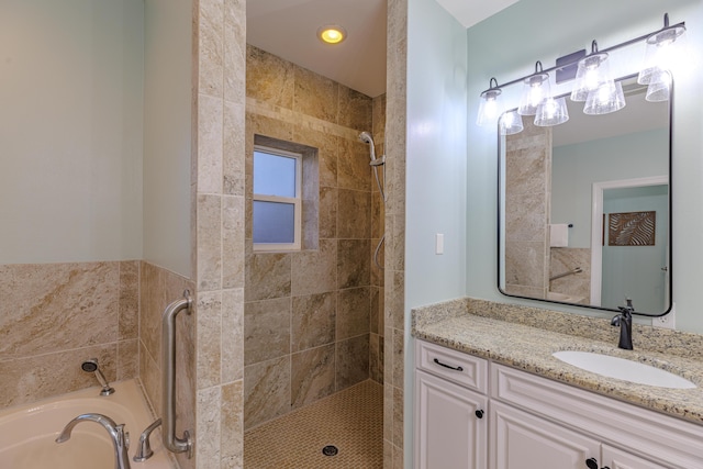 full bath featuring a garden tub, a shower stall, and vanity