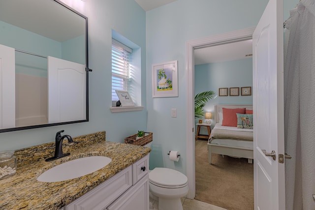 ensuite bathroom with vanity, toilet, and ensuite bathroom