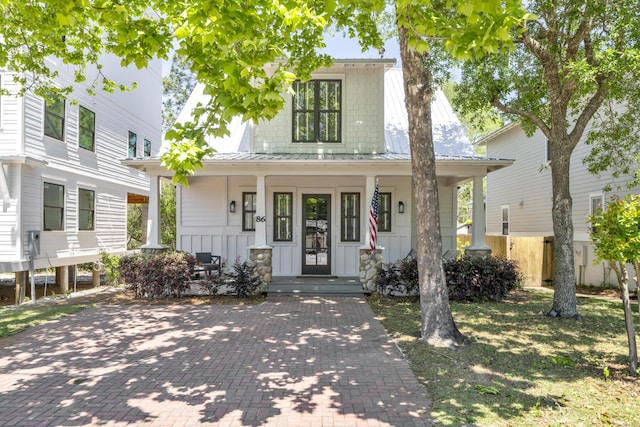 view of front of home featuring a porch, metal roof, and board and batten siding