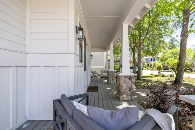 wooden terrace featuring covered porch