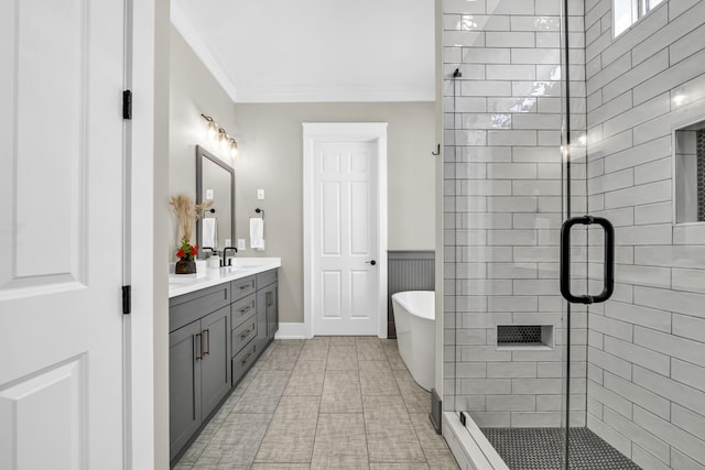 full bathroom with a freestanding bath, double vanity, a stall shower, and crown molding